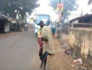 man-carrying-daughters-body-on-shoulder